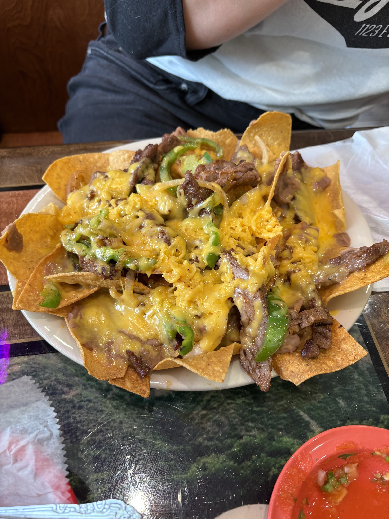 Loaded steak nachos with melted cheese and peppers