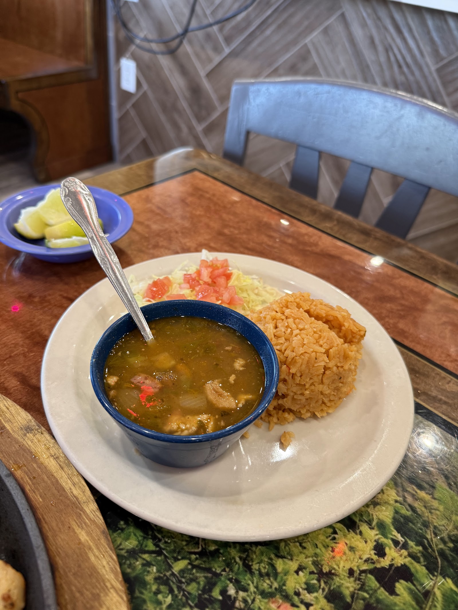 Bowl of menudo soup served with Mexican rice