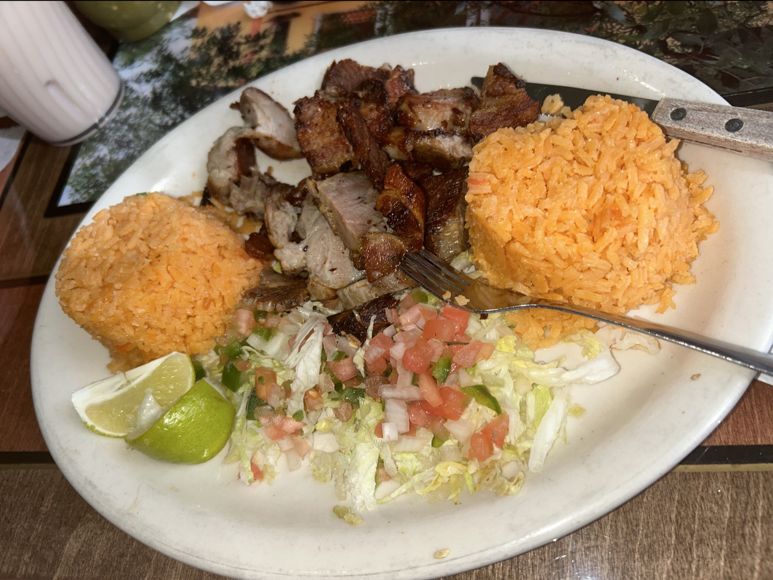 Carnitas plate with rice, pico de gallo, and fresh limes
